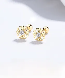 Detailed view of 925 silver gold-plated cross stud earrings with a sparkling zircon stone
