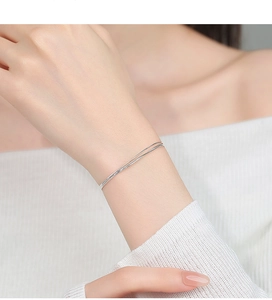 Detailed view of 925 sterling silver minimalist double-layered sleek bangle on wrist