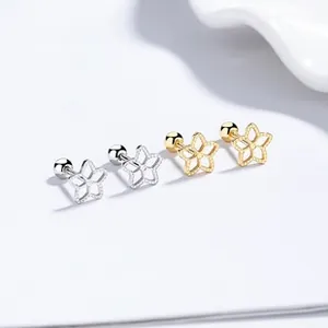 Detailed view of 925 silver hollow star earrings with gold and silver bead edge texture
