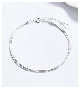 Close-up of triple-layered silver snake chain bracelet with adjustable lobster clasp