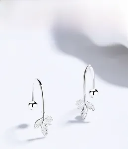 Macro shot of S925 sterling silver maple leaf earrings with detailed veins and texture