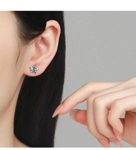 Macro shot of 925 silver star stud earrings with shimmering ice-cut zircon stones