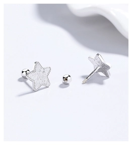 Macro view of 925 silver star earrings with textured surface and secure screw-back closure