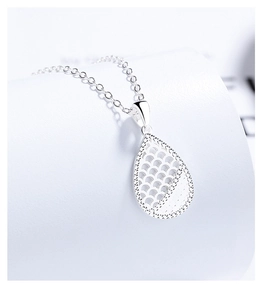 Macro shot of 925 silver hollow teardrop pendant with fine scale texture and chain