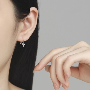 Elegant 925 sterling silver maple leaf drop earrings worn by a model for a natural look