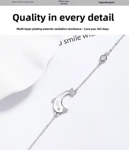 Detailed close-up of S925 sterling silver dolphin bracelet with LOVE engraving and zircon
