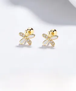 Macro view of 925 silver flower stud earring with white enamel and sparkling zircon detail