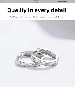 Detailed macro view of S925 sterling silver hoop earrings with zircon floral patterns