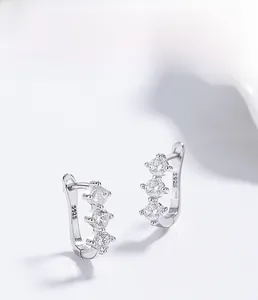 Macro shot of S925 sterling silver stamp and three-stone zircon inlay detail on earring