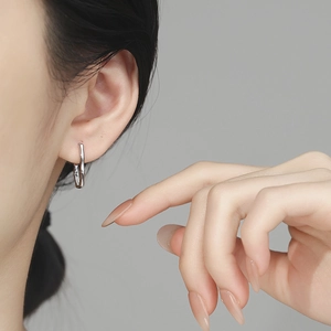 Elegant 925 sterling silver bamboo joint hoop earrings worn by a model with a clean backdrop