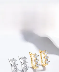 Detailed view of gold and silver S925 sterling silver earrings with three vertical zircons
