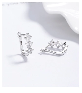 Close-up of S925 sterling silver earrings with three sparkling round zircons
