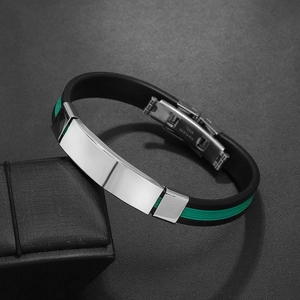 Detail of stainless steel clasp and green Greek key pattern on black silicone strap