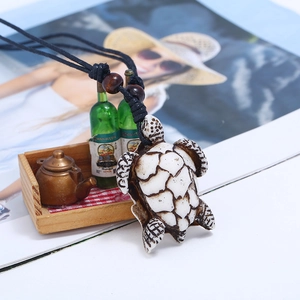 Handcrafted resin sea turtle pendant necklace with vintage texture and black cord