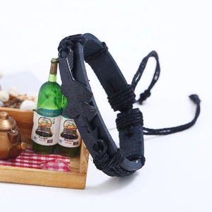 Braided black faux leather couple bracelet with arrow-through-heart metal charm