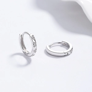 S925 sterling silver hoop earrings with zircon clover design on a white background