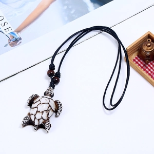 Handmade woven turtle pendant necklace with resin sea turtle and adjustable black cord