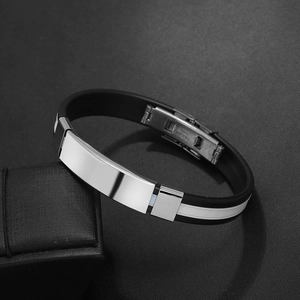 Detail of black silicone men's bracelet with polished stainless steel plate and folding clasp