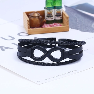 Detail of multi-layered braided black leather bracelet with black infinity symbol