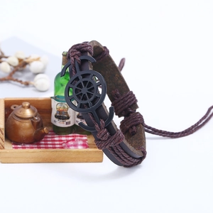 Vintage dark brown braided leather bracelet with black anchor and helm nautical charms