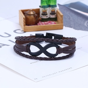 Detailed macro shot of leather braided bracelet featuring a matte black infinity symbol charm