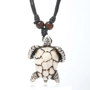 Handcrafted resin turtle pendant necklace with black woven cord and tribal wood beads