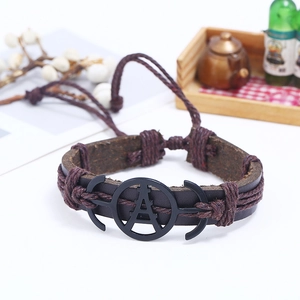 Detail of vintage leather bracelet featuring Eiffel Tower metal charm and anchor clasp