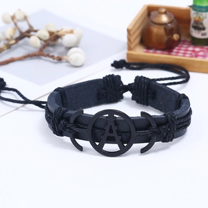 Retro multi-layer black braided leather bracelet featuring a vintage metal center charm