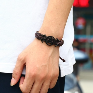Retro multi-layer woven leather bracelet for men featuring dark brown cord and metal charms