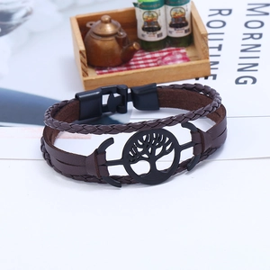 Brown multi-layer leather bracelet featuring a black Tree of Life charm and toggle clasp