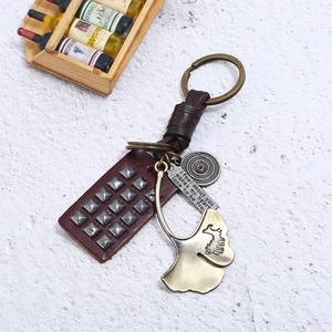 Vintage woven cowhide keychain with bronze ginkgo leaf and engraved metal pendant