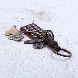 Vintage braided leather keychain with bronze ginkgo leaf and engraved punk metal charms
