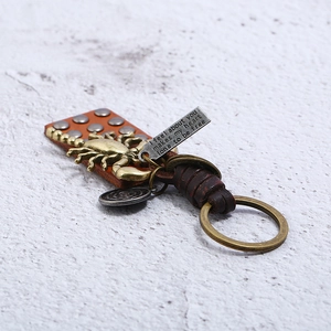 Vintage punk hand-woven leather keychain with bronze scorpion pendant and metal tag