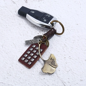 Vintage braided cowhide keychain with bronze ginkgo leaf and engraved metal tag