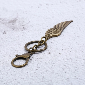 Vintage bronze alloy feather wing keychain with lobster clasp and metal ring pendant