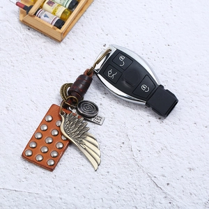 Vintage braided leather keychain set with metal feather charm and car key fob