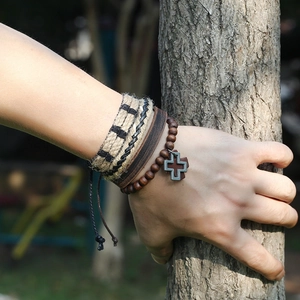 Handmade vintage leather bracelet set with wooden beads and a metal cross pendant