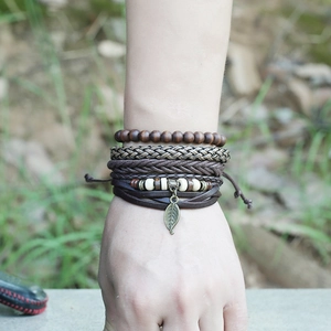 Men's retro woven leather bracelet set with wooden beads and leaf charm on wrist