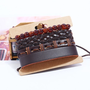 Retro multi-layer woven leather bracelet set with reddish beads on a display card