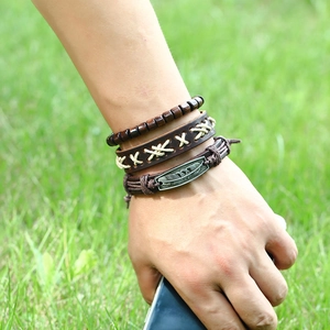 Retro multi-layer leather bracelet set with wooden beads and bronze feather charm
