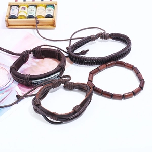 Set of four vintage woven leather bracelets with believe charm and wooden beads
