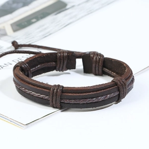 Close-up of vintage braided brown leather bracelet with adjustable drawstring closure
