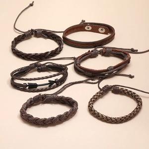 Detail of 6-piece men's vintage multilayer braided leather bracelets with metal arrow charm