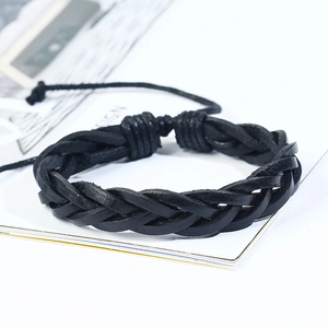Close-up of black braided leather bracelet with adjustable cord and textured weave details