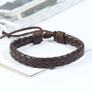 Close-up of a dark brown braided leather bracelet with an adjustable drawstring closure
