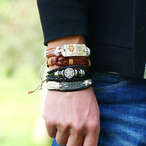 Detail of vintage layered men's bracelets with leather cords and alloy star charms
