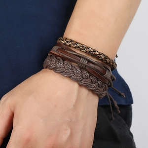 Close-up of men's multilayer braided leather bracelet set with retro punk textures
