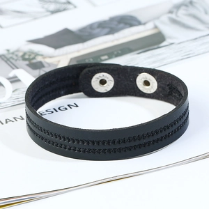 Minimalist black leather bracelet featuring double stitching and metal snap closure