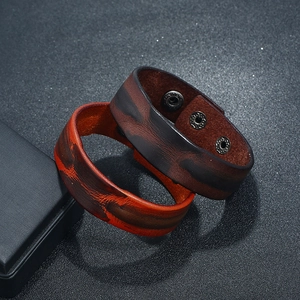 Vintage wide leather cuff bracelets in brown and tan with adjustable metal snap buttons