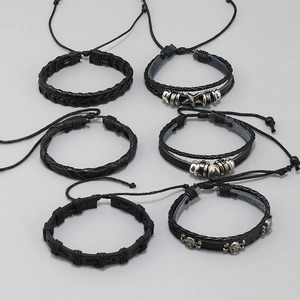 Detail of 6-piece punk leather bracelet set with skull and star charms for men